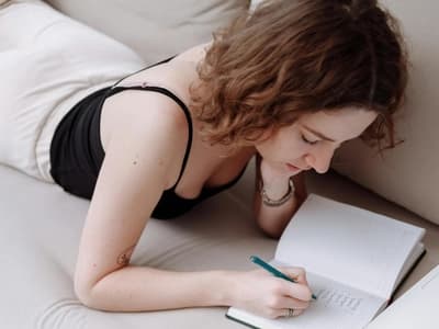A woman is writing her daily schedule.