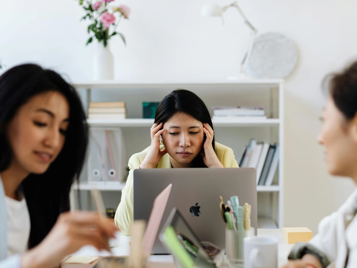 A woman feeling stressed at work, reflecting common ADHD symptoms in women