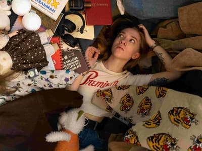 Lying in a whirlwind of creative chaos, her mind drifts. A quiet, contemplative moment in the beautifully cluttered world of ADHD